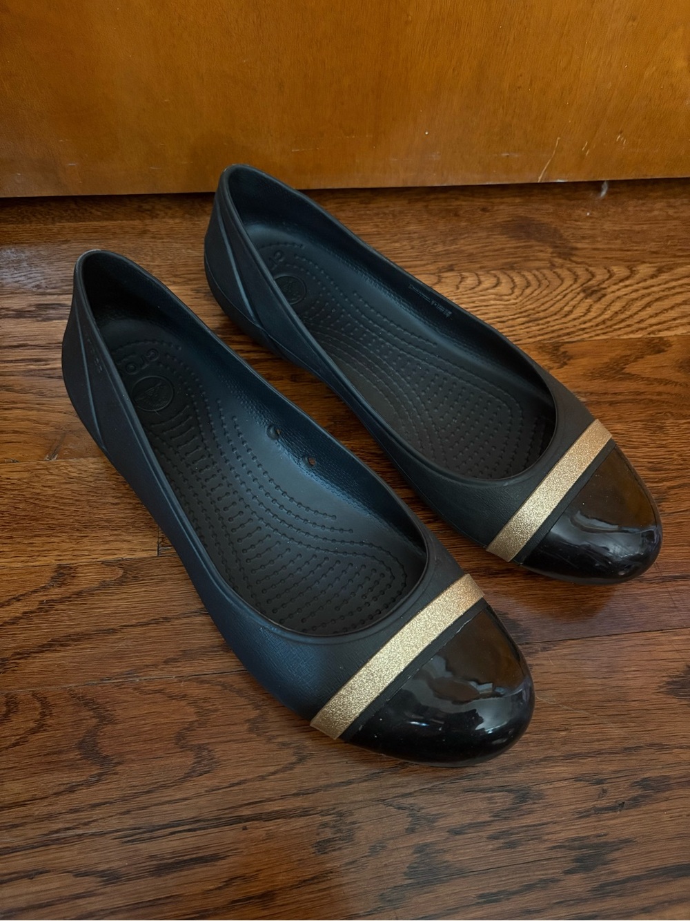 CROCS Black Flats with Gold Accent Toe slip on, cushion